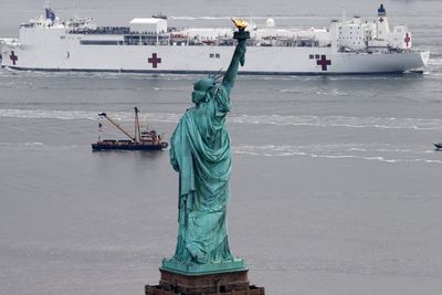 Statue of Liberty as USNS Comfort arrives at NYC to help people with Coronavirus