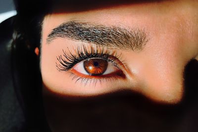 close up of a girls long lashes and brows