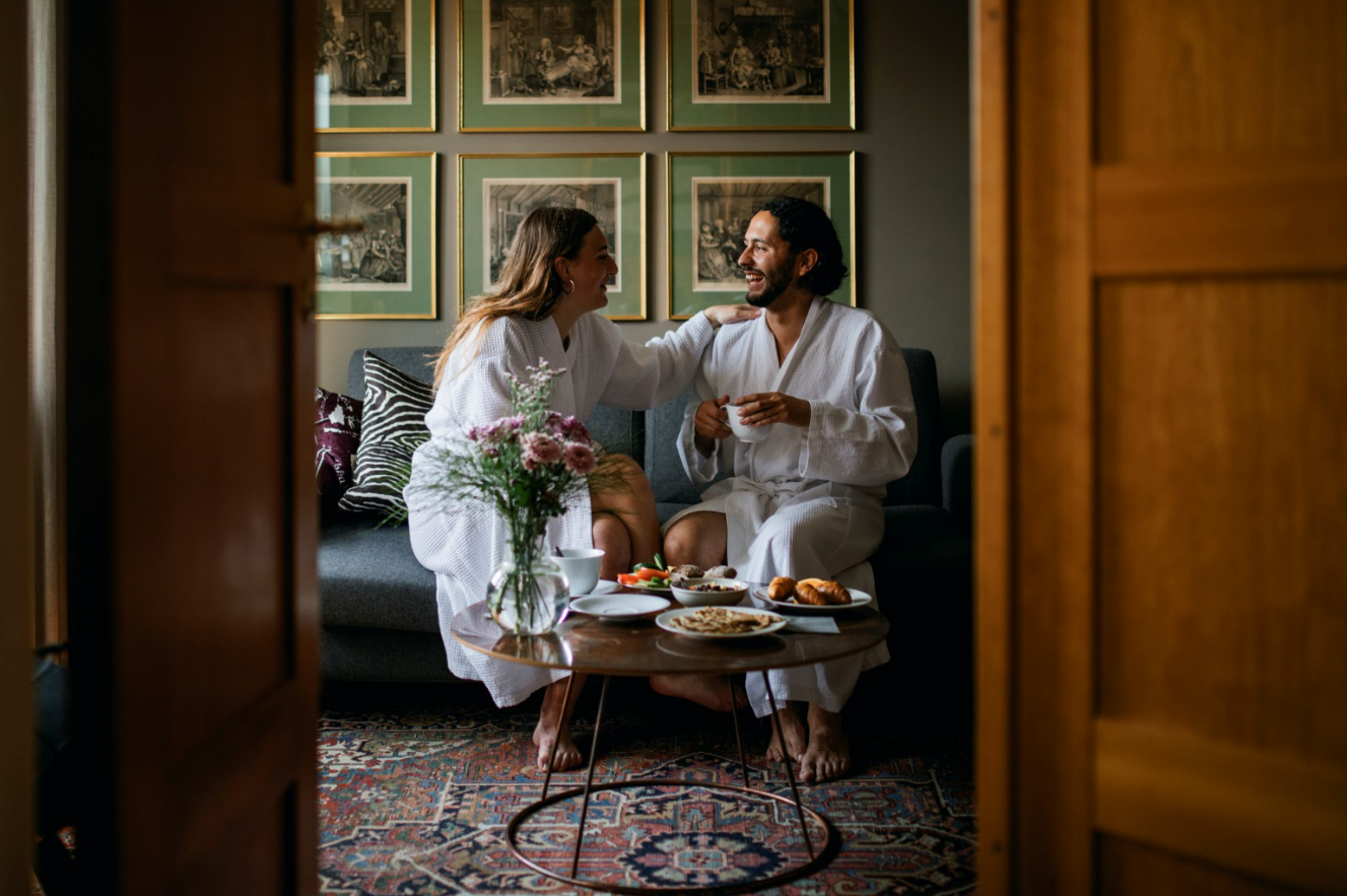  couple in robes eating 